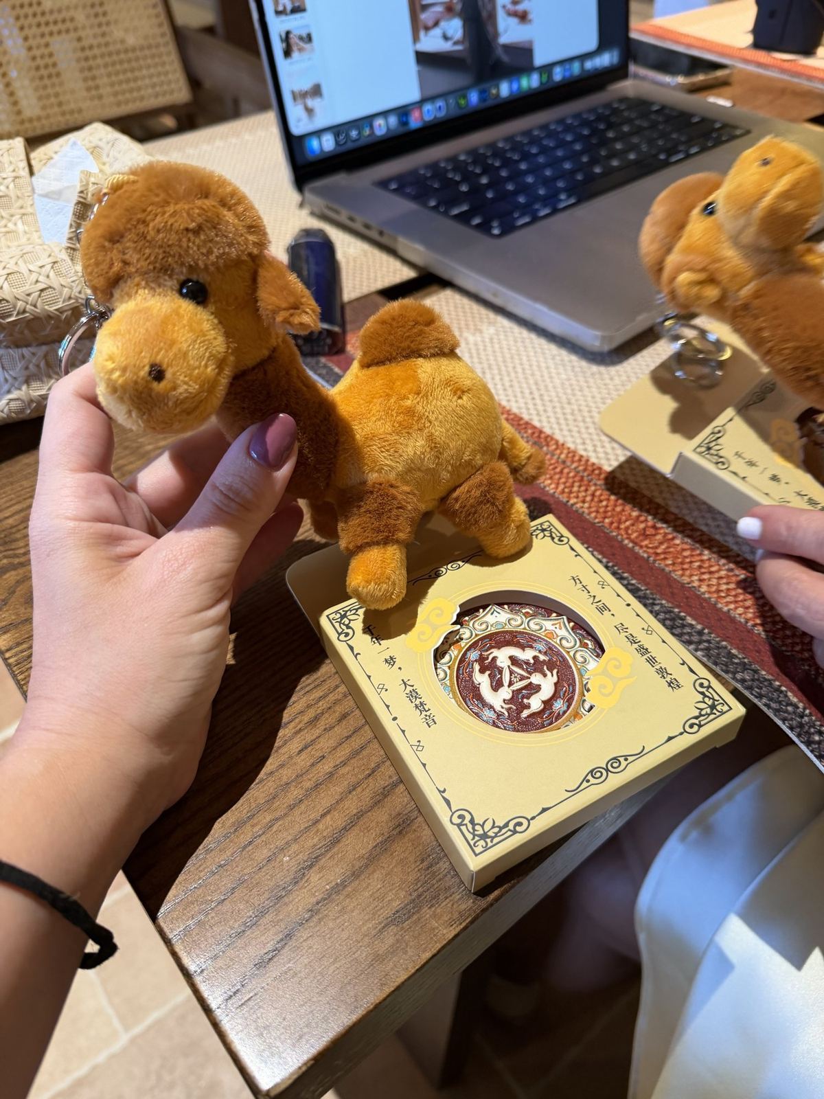 A plush camel and a stamped Dunhuang souvenir box at the Boman Oasis Resort