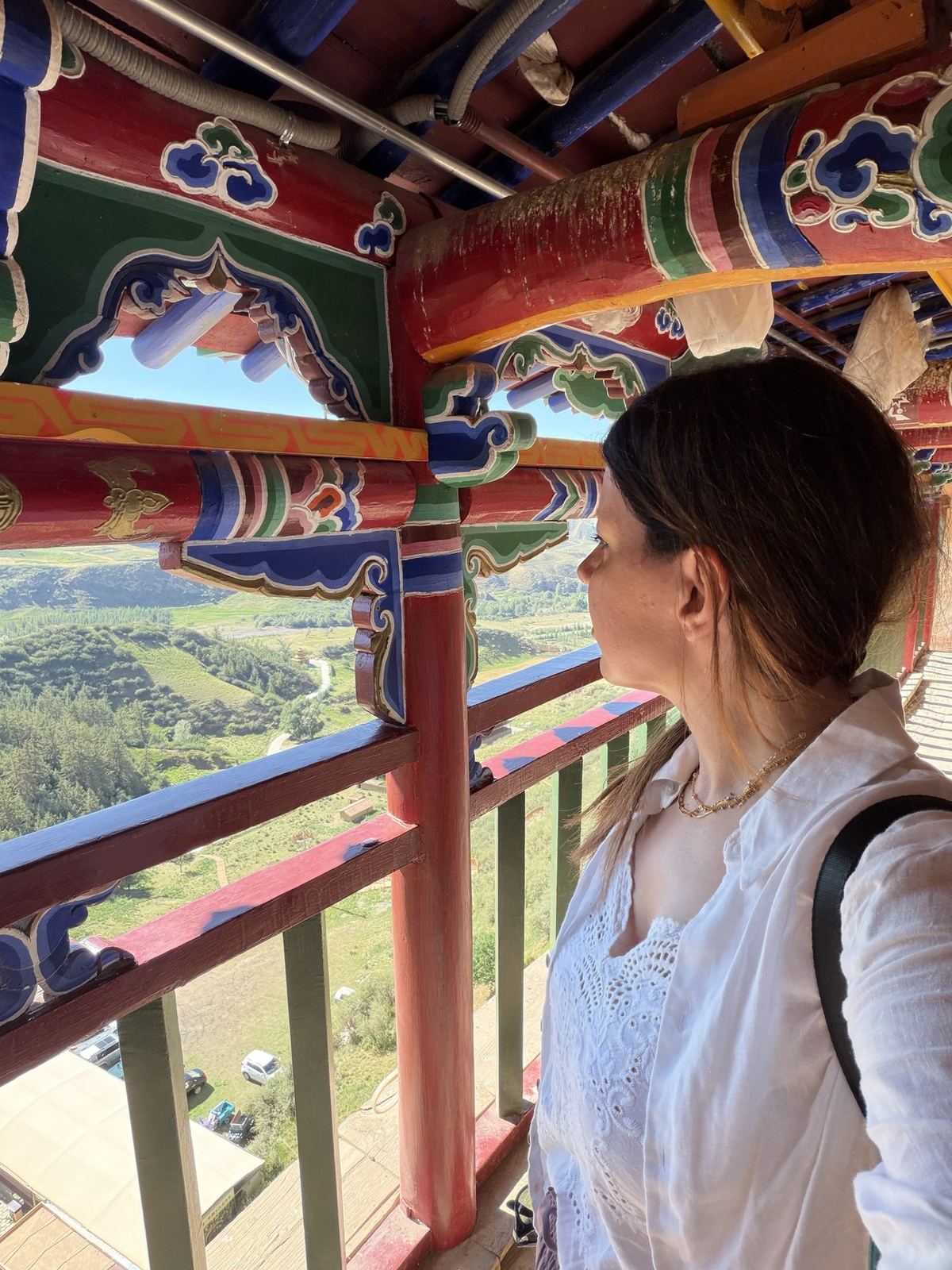 Linda looking out from a painted balcony at Mati Temple