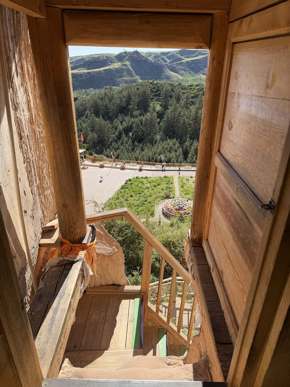 View of the valley from a wooden stairway inside the Mati Temple cliff