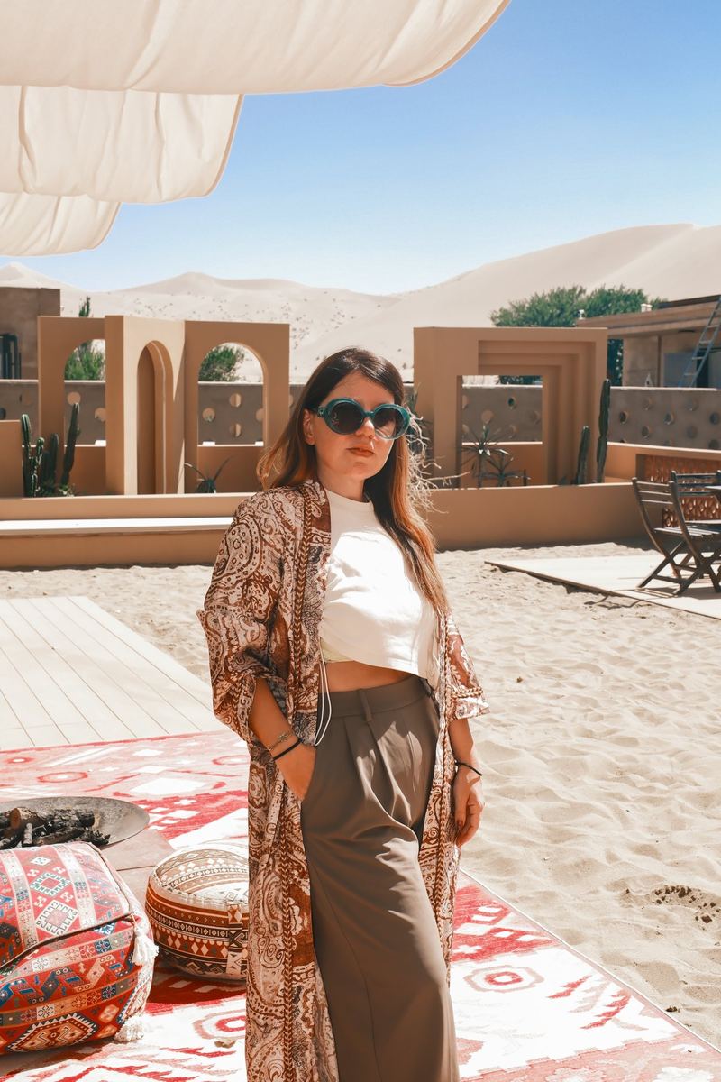 The Boman Oasis Resort terrace with the Mingsha Shan dunes behind