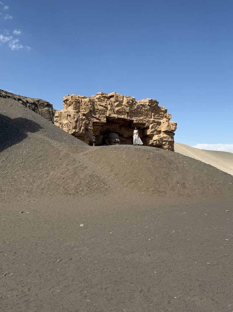 Laughing Buddha cave on top of a sand dune at the Dunhuang Silk Road Heritage City