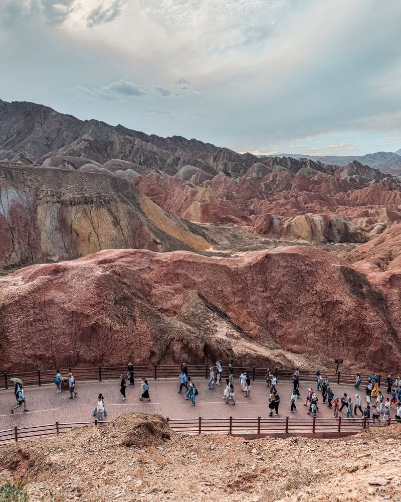 A valley of red and yellow ridges seen from a Zhangye Danxia viewpoint