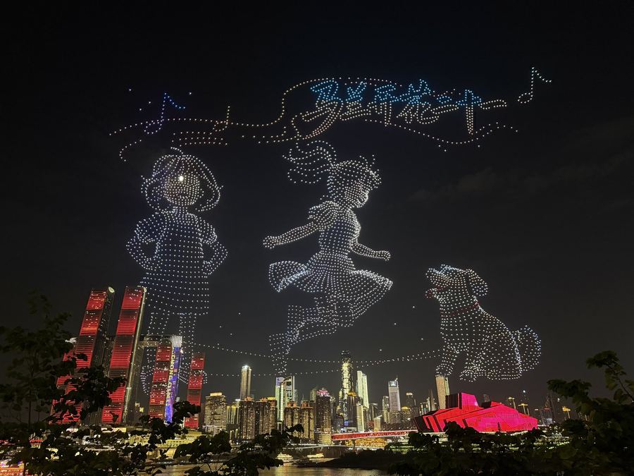 Thousands of drones drawing two children and a dog above Raffles City and the Chongqing Grand Theatre at night