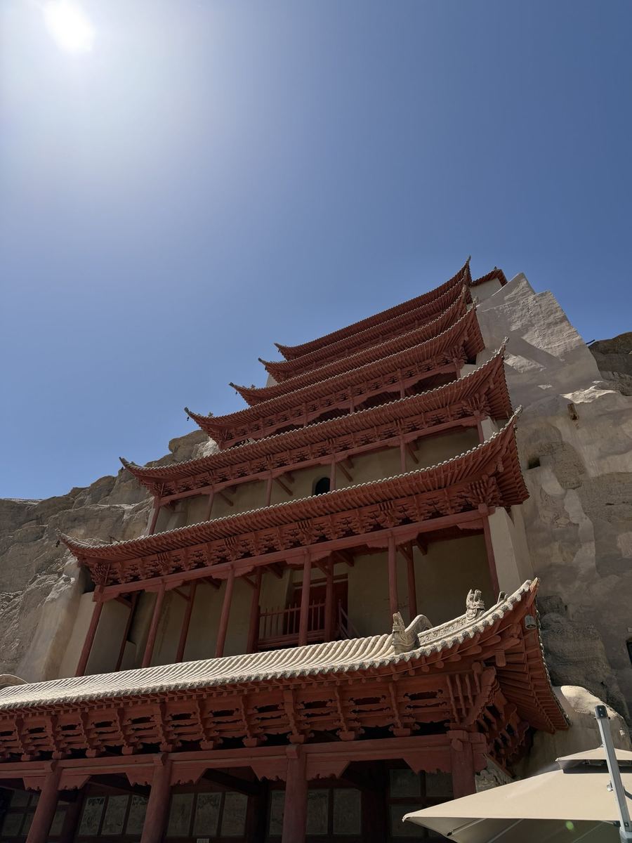 The red Nine Storey pagoda of the Mogao Caves against a blue sky