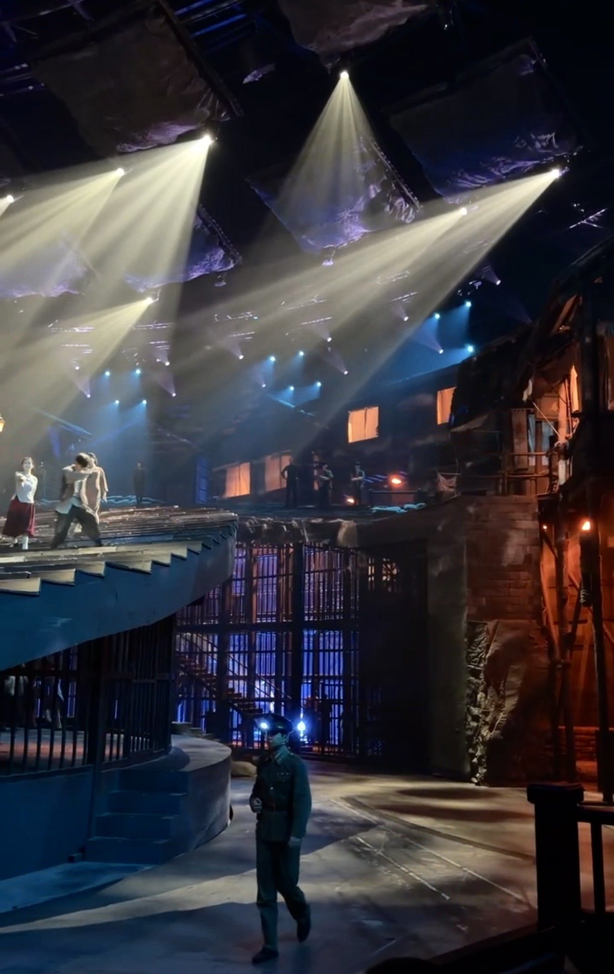 Spotlights over the rotating stage sets of the Chongqing 1949 show