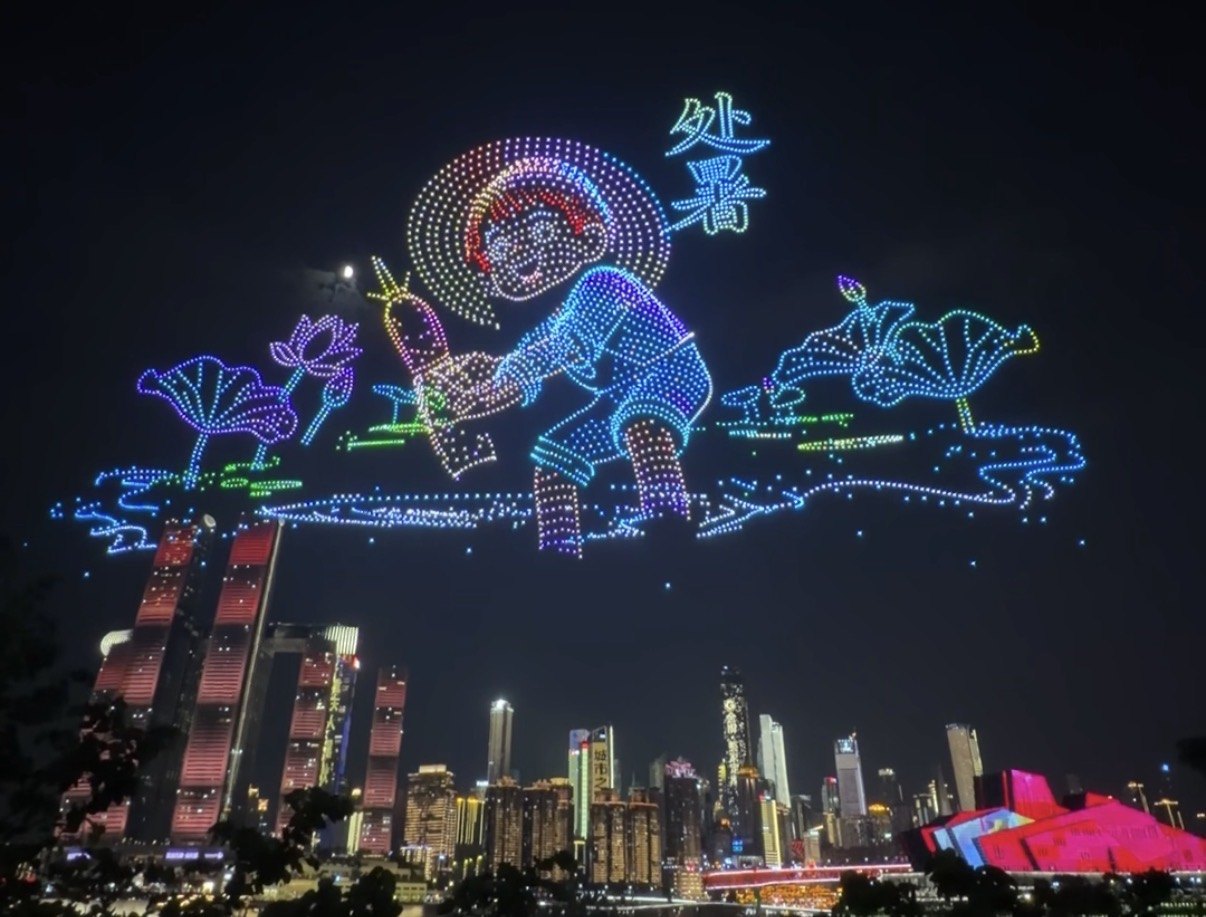 Drones drawing a boy in a straw hat among lotus leaves over Chongqing