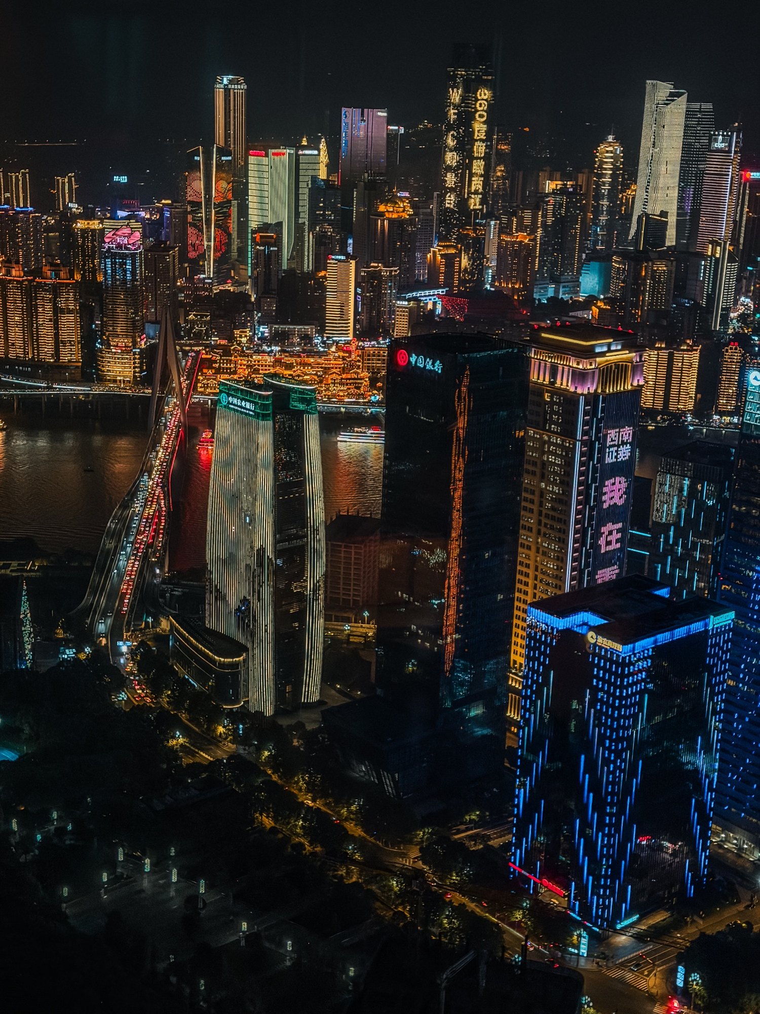 The Chongqing skyline lit up at night seen from high above