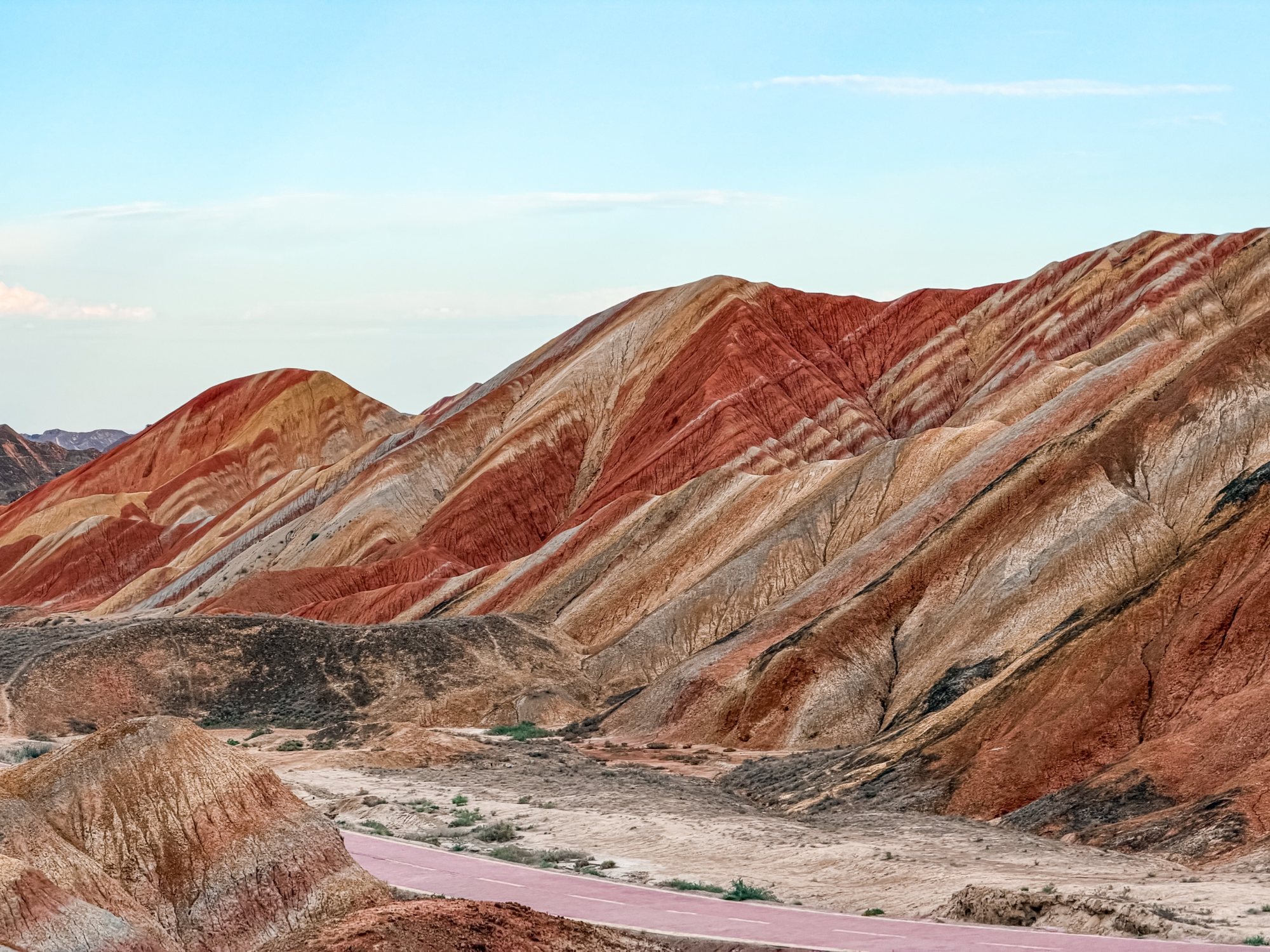 Red and gold slopes of the Zhangye Danxia above the park road